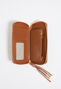 Brown leather wallet with a zip closure, multiple card slots, a transparent ID window, and a zippered coin pocket. Textured tassel detail.