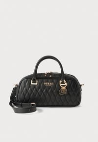 Black quilted handbag with gold hardware, dual handles, and detachable shoulder strap. Features brand logo and decorative charm detail.