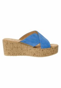 Des sandales à talons compensés en suède bleu avec une semelle en liège, dotées d'un design à lanières croisées et d'une surface intérieure lisse pour plus de confort.