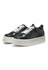 Black patent leather sneakers with white laces and a thick white rubber sole. Features a textured design and a pull tab at the back.