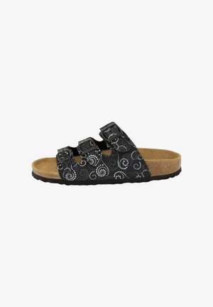 Black slide sandals with three adjustable buckles, decorative swirl pattern, cork footbed, and textured rubber outsole.