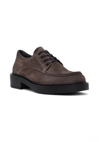 Chaussures en daim marron à lacets avec un bout rond, semelle en caoutchouc noir et détail de couture contrastant le long du bord de la tige.