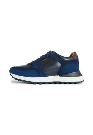 Men’s navy blue sneaker with suede and leather panels, white thick sole, and black tread, shown from the side on a white background.