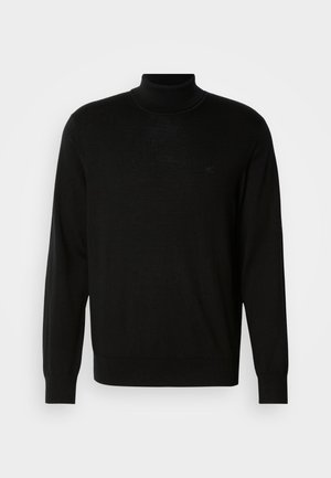 Zwarte coltrui van fijn gebreide stof met lange mouwen en een getailleerde pasvorm. Heeft minimale branding op de borst.