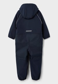 Námořnická modrá dětská kombinéza s kapucí, elastickými manžetami, reflexními detaily a hladkou texturou. Má jednoduchý design a poskytuje plné pokrytí.