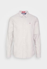 Lichtgrijs shirt met lange mouwen, gemaakt van katoen, met een button-down kraag, knopen aan de voorkant en een klein geborduurd logo op de borst.