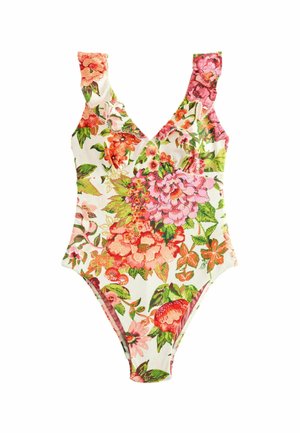 Floraler Stoff mit pinken und grünen Blumen, die einen großen ovalen Ausschnitt und ein kleines Metallschild nahe der Mitte umgeben.