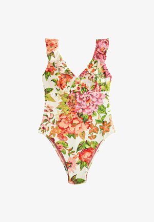 Floraler Stoff mit pinken und grünen Blumen, die einen großen ovalen Ausschnitt und ein kleines Metallschild nahe der Mitte umgeben.