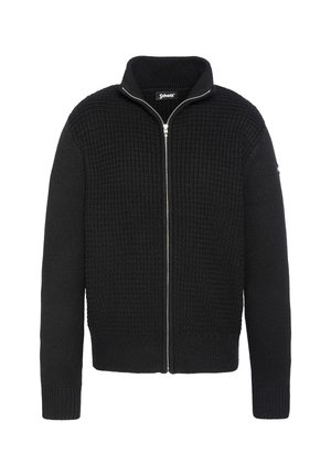 Pull en tricot noir zippé avec un motif texturé en forme de gaufre. Il présente un col montant et des poignets et un ourlet côtelés. Détail de fermeture éclair argentée.
