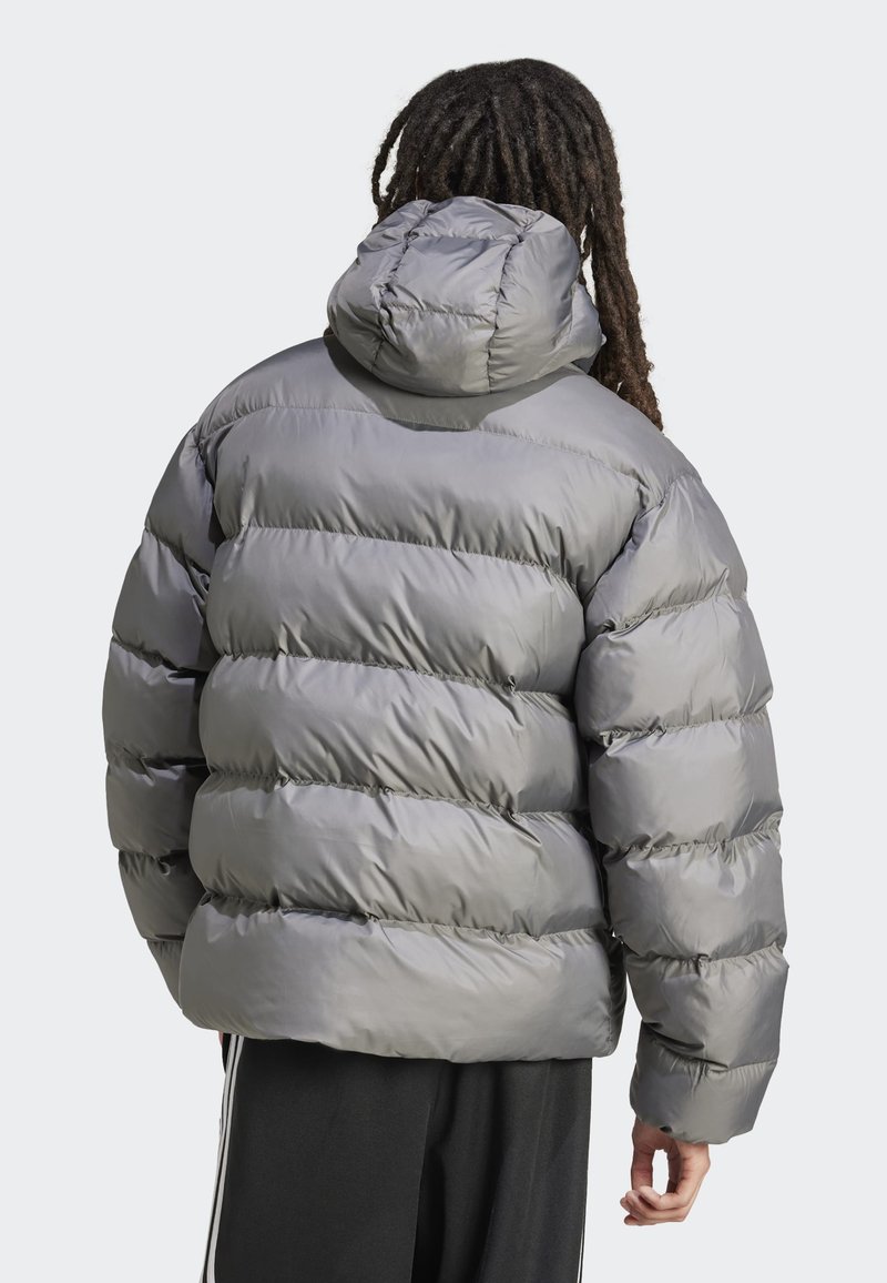 Doudoune grise avec capuche, présentant des sections matelassées épaisses, une texture lisse et des poignets élastiques, vue de l'arrière.