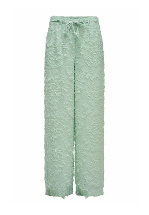 Pantalon large vert clair avec tissu texturé à franges et taille à cordon, présenté sur un fond blanc.
