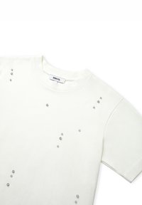 T-shirt en coton blanc à manches courtes, décoré de strass clairs dispersés sur le devant et d'un col rond côtelé.