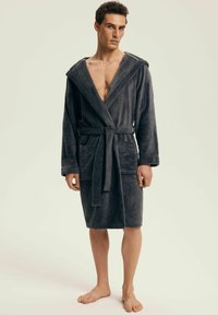 Gray, hooded bathrobe made of soft fabric, featuring a belt, front pockets, and a relaxed fit, reaching just above the knee.