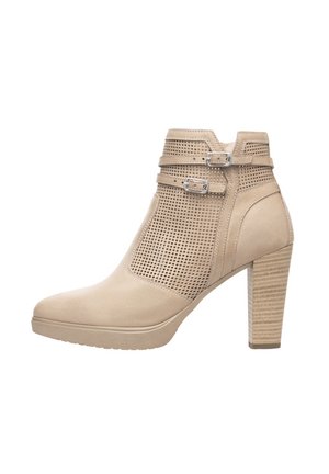Bottines beiges avec un design perforé, boucles latérales et un talon bloc texturé. Matériau supérieur lisse et forme de bout arrondi.