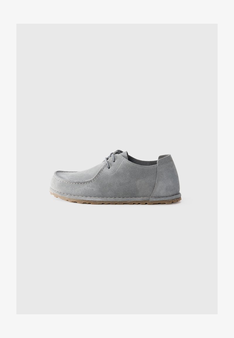 Light gray suede casual lace-up shoe with rubber sole, low heel, and stitched moc toe design on plain light background.