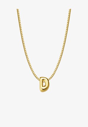 Auksinis vėrinys, kuriame yra apvalus raidės "D" pakabutis, pritvirtintas prie mažo grandinėlės su dailiu paviršiumi ir lygiu tekstūriškumu.