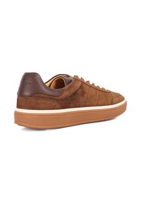 Brown suede sneaker with white laces, a contrasting tan sole, and dark brown leather accent at the heel. Features clean line design.