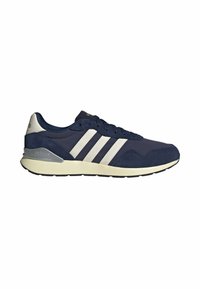 Baskets Adidas bleu marine avec bandes blanches, semelle beige, maintien du talon gris et fermeture à lacets, vues de profil.