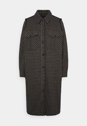 Black and brown checkered shirt dress with two chest pockets, a button front closure, and a collar. Made from a textured fabric.