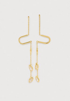 Zlato obarvane viseče uhane imajo edinstveno U-obliko z verižico in prozornimi akcenti v obliki marquise očes.