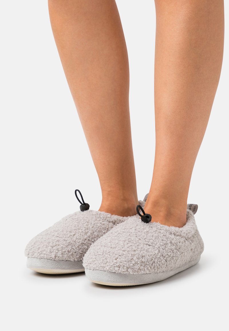 Gray fleece slippers with soft, textured exterior, rounded toe, and black accent loops; cushioned sole for comfort.