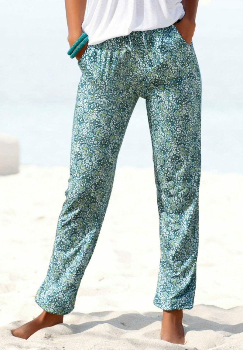 Pantalones de lounge de estampado floral en color téal, con cinturilla elástica y un corte holgado, con patrones de flores blancas y azules esparcidos por todo el tejido.