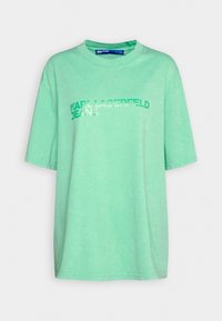 Mentolově zelené oversized tričko s krátkým rukávem a potiskem "Karl Lagerfeld Jeans" přes hrudník v odpovídajících odstínech zelené.