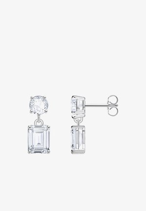Stud earrings with round and emerald-cut clear gemstones set in silver metal, one shown front-facing, the other in side view.
