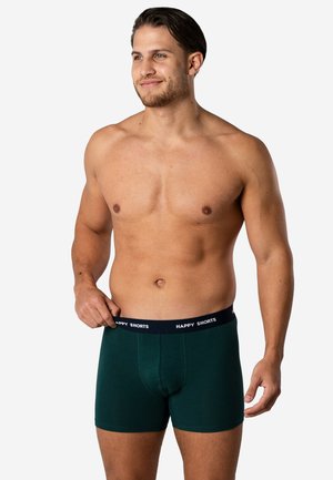 Donkergroene boxershorts met een marineblauwe tailleband waarop "HAPPY SHORTS" staat. Voorzien van een aansluitend ontwerp en een gladde stoftextuur.