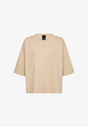 Bež majica kratkih rukavov oversized kroja z okroglim izrezom in vidno šivano ob robu ter rokavih.
