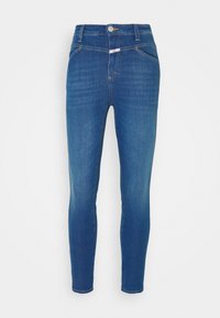 Jeans ajustados en denim azul oscuro con una textura suave, que cuentan con un diseño de cinco bolsillos, cierre de botón y un ligero desvanecimiento en los muslos.