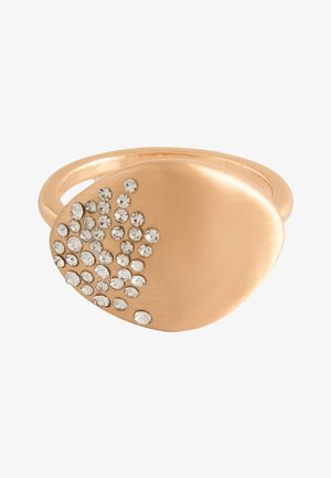 Gold-tone ring with an oval top featuring a cluster of small clear rhinestones on one side against a white background.