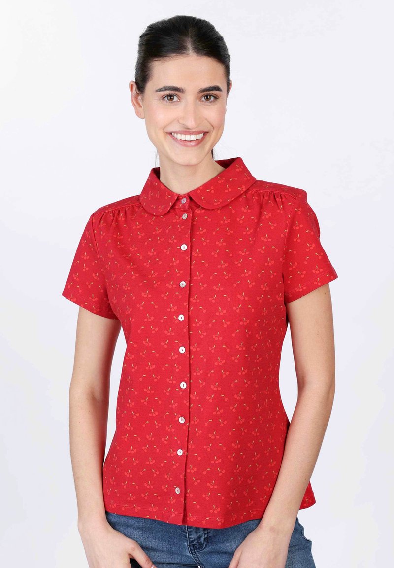 Red short-sleeve shirt featuring a collar, button front, and a cherry pattern; made of smooth fabric with slight gathering at shoulders.