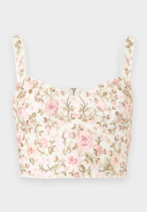 Λευκό κοντό τοπ με ροζ και πράσινη λουλουδένια κεντητική και λεπτές τιράντες, με μικρό κεντρικό φερμουάρ στο ντεκολτέ.