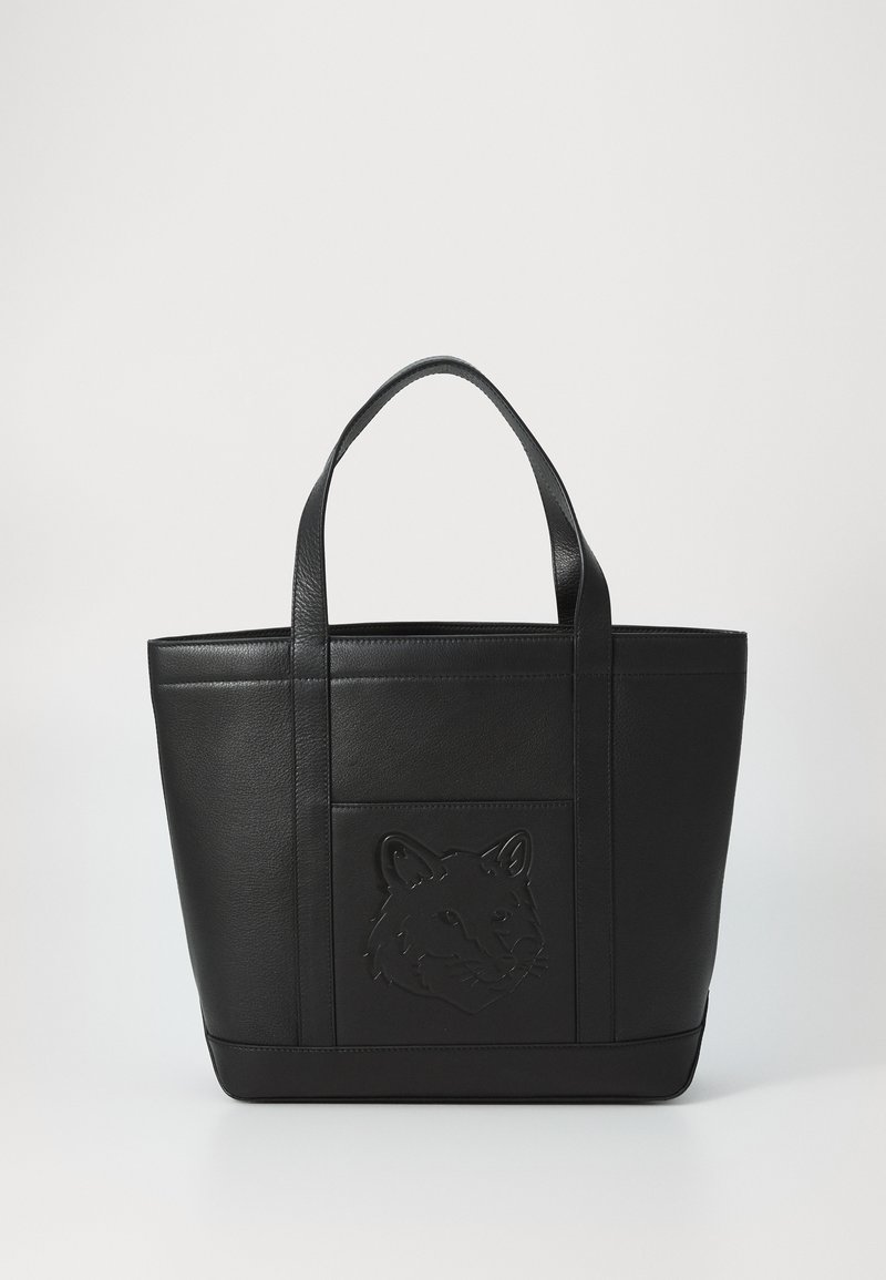 Black leather tote bag with tall, rectangular shape. Features embossed animal head design on front, dual top handles, and textured finish.