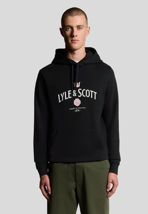Sort hættejakke lavet af bomuldsblanding med en frontlomme, der har et hvidt logo og en pink detalje. Løs pasform, justerbar snor i hætten.