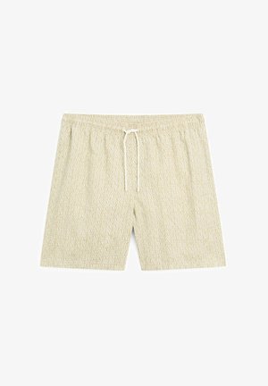 Lys beige badebukser med et abstrakt bølget mønster, elastisk talje og snøre. Fremstillet af blødt, åndbart stof.