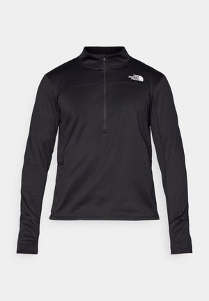 Black long-sleeve pullover made of textured fabric, featuring a quarter zip and a small logo on the chest. Fitted sleeves with thumb holes.