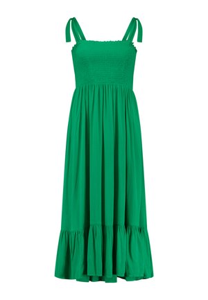 Zöld, ujjatlan ruha smockolt felsőrésszel, vékony pántokkal és fodros szegéllyel. Könnyű anyagból készült, folyékony vonalvezetés jellemzi.