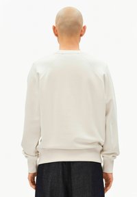 Light gray sweatshirt with a crew neckline, raglan sleeves, and ribbed cuffs. The back features a smooth, plain finish without embellishments.