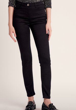 Black skinny jeans made of stretchy fabric, featuring a high waist, front pockets, and a metallic button closure. Smooth texture with a fitted design.