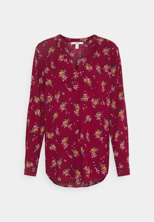 Bordeaux langemouwen shirt met bloemenprint, voorzien van een V-hals, zachte stof en een gebogen zoom, met kleine witte en gele accenten.
