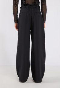 YOURTURN UNISEX - Tygbyxor - black