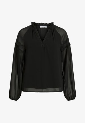 Svart blus med V-ringning, volangkrage, genomskinliga långa ärmar och spetsdetaljer på axlarna. Lätt och flödande tyg.