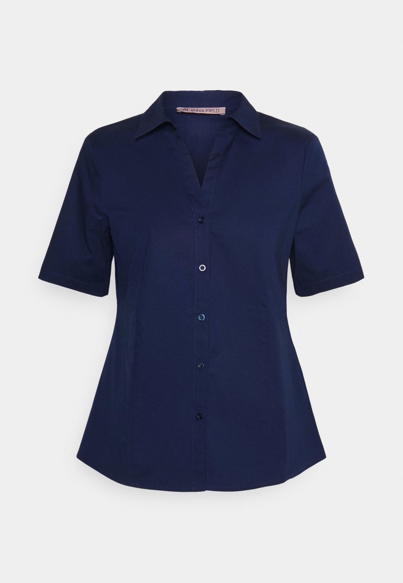 Blouse bleu marine à manches courtes avec col, fermeture à boutons sur le devant et légère évasement à la taille.
