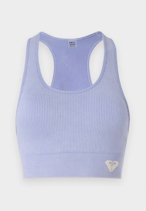 Light purple ribbed sports bra with a scoop neck and racerback design, featuring a small heart logo in the lower corner.
