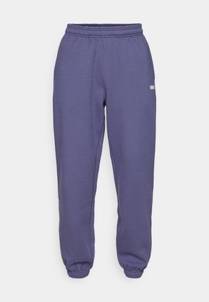Purple sweatpants with an elastic waistband, tapered legs, and ribbed cuffs; made from a soft, textured fabric. Small logo detail on side.