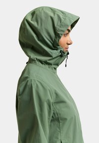 Hellgrüne Kapuzenjacke aus leichtem Stoff. Verfügt über eine verstellbare Kapuze und Reißverschlussverschlüsse, mit einer glatten Textur und minimalistischem Design.