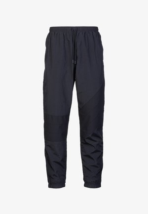 Pantaloni jogger leggeri di colore blu navy con vita elastica, cordoncino e pannelli testurizzati lungo i lati. Caviglie con polsino fitted.