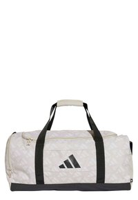 Il borsone presenta un tessuto beige chiaro con un motivo geometrico, accenti neri, manici robusti e un compartimento principale con zip.